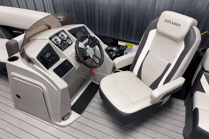 Slide: The Image of 2026 Sylvan Mirage X1 boat cockpit with steering wheel and captain's chair. - 7