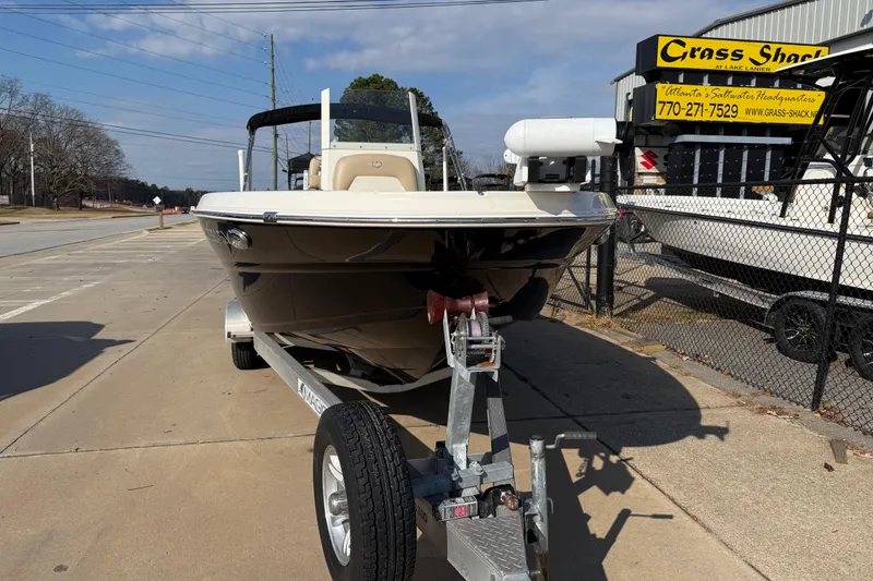 Slide: The Image of 2019 Stingray 236 CC boat on trailer at dealership, sunny day. - 1
