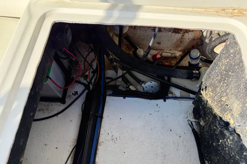 Slide: The Image of 2019 Stingray 236 CC boat interior showing wiring and components. - 15