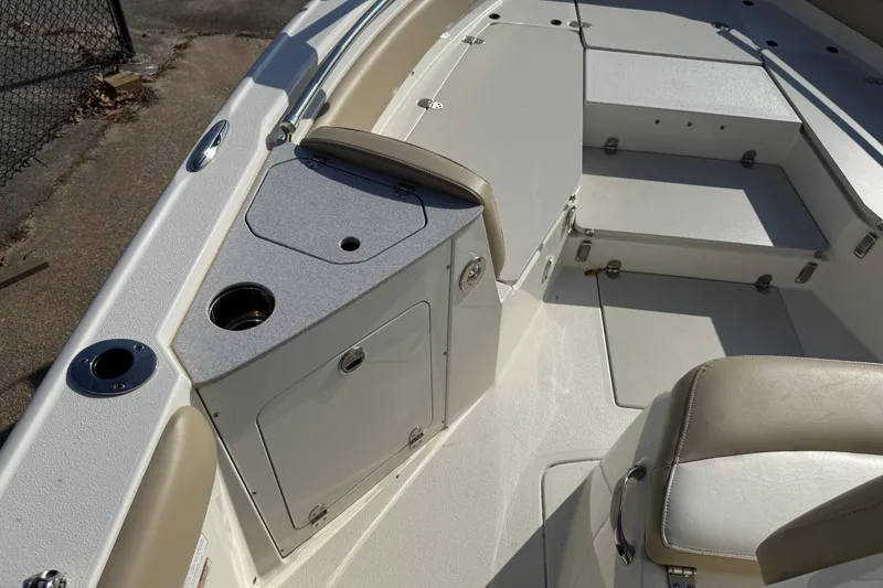 Slide: The Image of 2019 Stingray 236 CC boat interior with seating and storage compartments. - 16