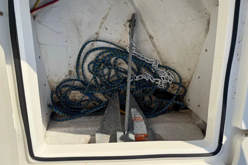 Slide: The Image of Anchor storage compartment in 2019 Stingray 236 CC boat with rope and chain. - 23