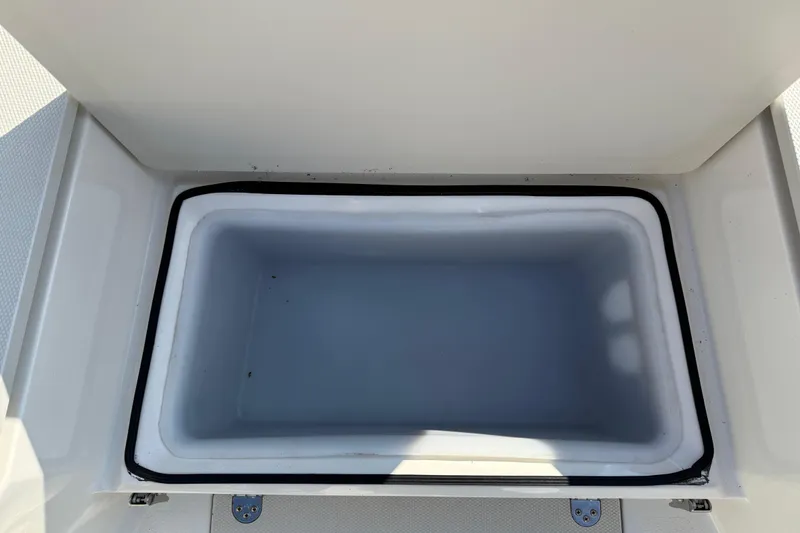 Slide: The Image of Open storage compartment on a 2019 Stingray 236 CC boat. - 24
