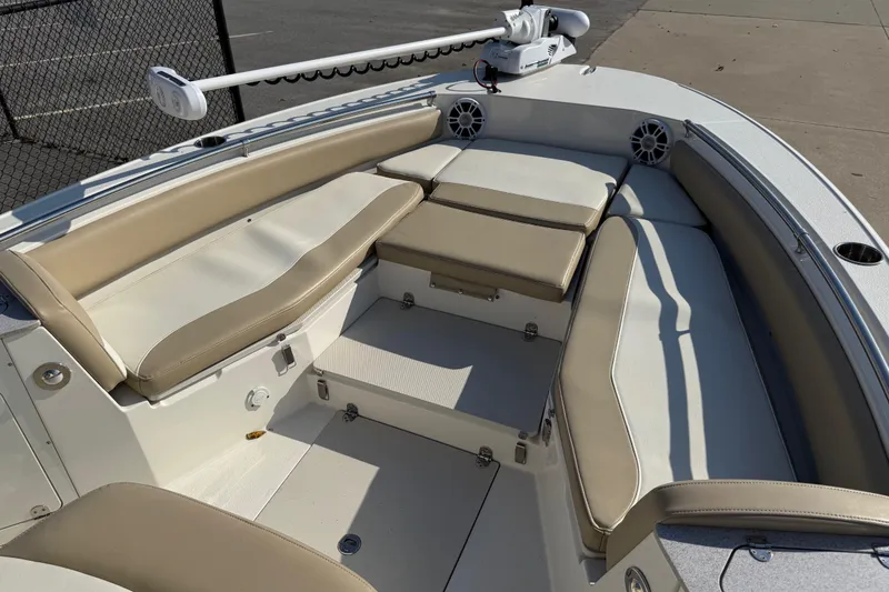 Slide: The Image of 2019 Stingray 236 CC boat interior with beige seating and modern design. - 29