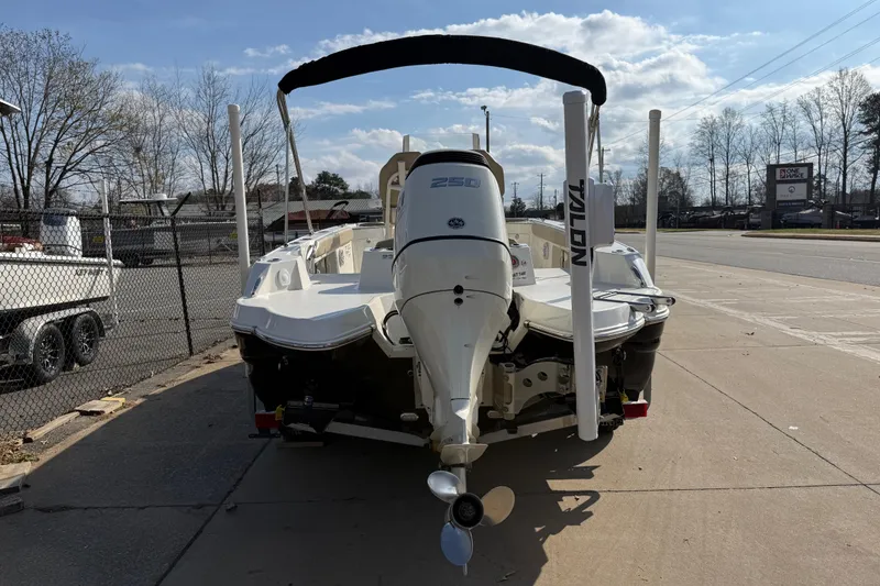 Slide: The Image of 2019 Stingray 236 CC boat with outboard motor, parked on a sunny day. - 3
