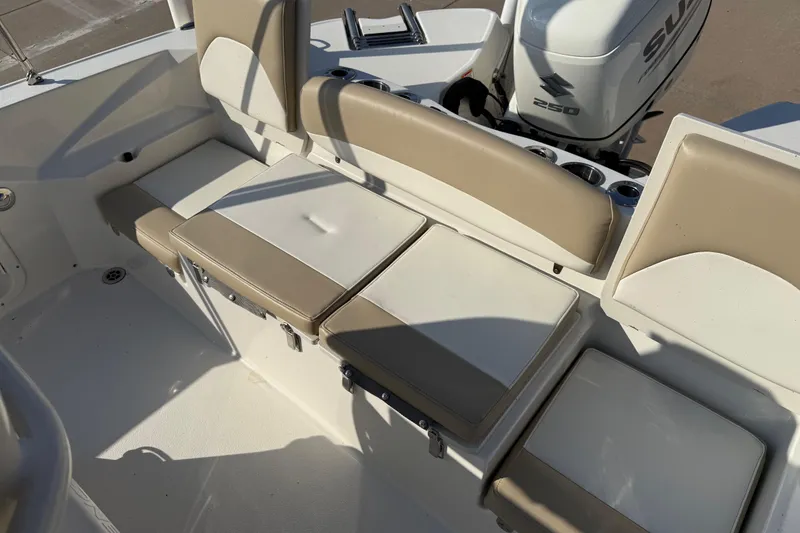 Slide: The Image of 2019 Stingray 236 CC boat interior with beige seating and Suzuki 250 engine. - 30