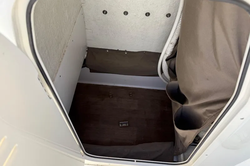 Slide: The Image of Interior storage compartment of a 2019 Stingray 236 CC boat, featuring a compact design. - 31