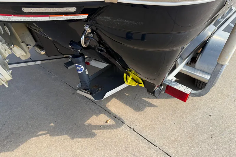 Slide: The Image of 2019 Stingray 236 CC boat on trailer, showing rear hull and trim tab. - 34
