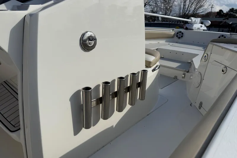 Slide: The Image of 2019 Stingray 236 CC boat interior with rod holders and seating area. - 36