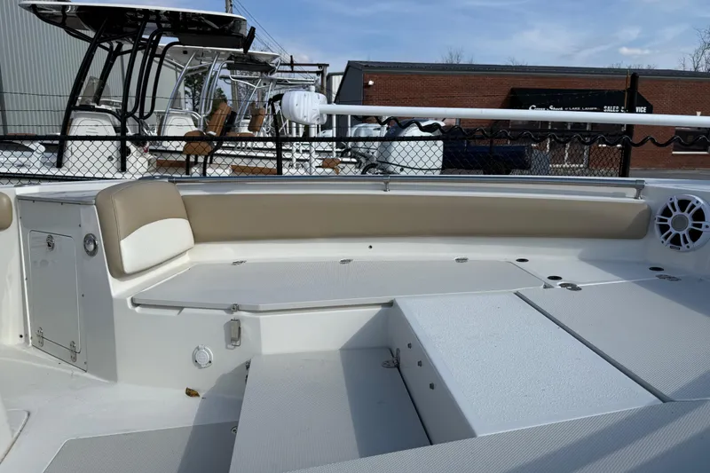 Slide: The Image of 2019 Stingray 236 CC boat interior with beige seating and storage compartments. - 38