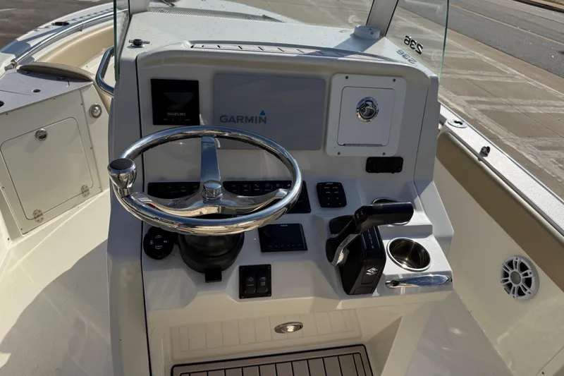 Slide: The Image of 2019 Stingray 236 CC boat console with Garmin navigation and Suzuki controls. - 7
