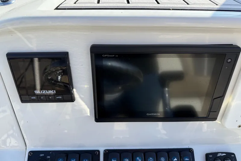 Slide: The Image of Control panel of 2019 Stingray 236 CC with Suzuki and Garmin displays. - 9