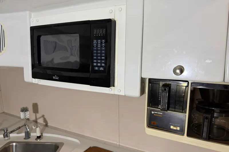 Slide: The Image of 1988 Trojan 13 Meter Express 430 kitchen with microwave and coffee maker. - 10