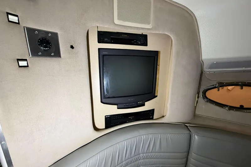Slide: The Image of 1988 Trojan 13 Meter Express 430 interior with vintage Sony TV and leather seating. - 11