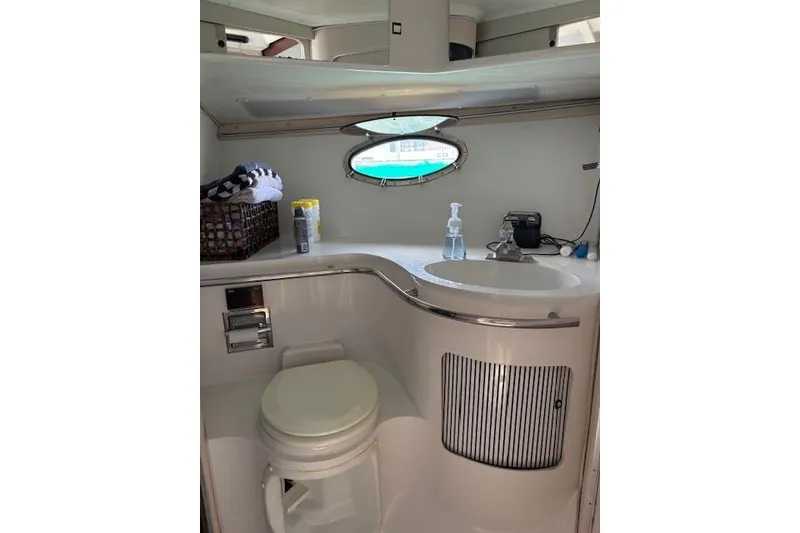 Slide: The Image of Bathroom interior of 1988 Trojan 13 Meter Express 430 yacht, featuring sink and toilet. - 14
