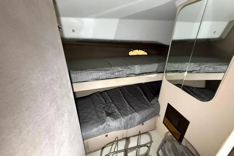 Slide: The Image of 1988 Trojan 13 Meter Express 430 cabin with bunk beds and mirror. - 15