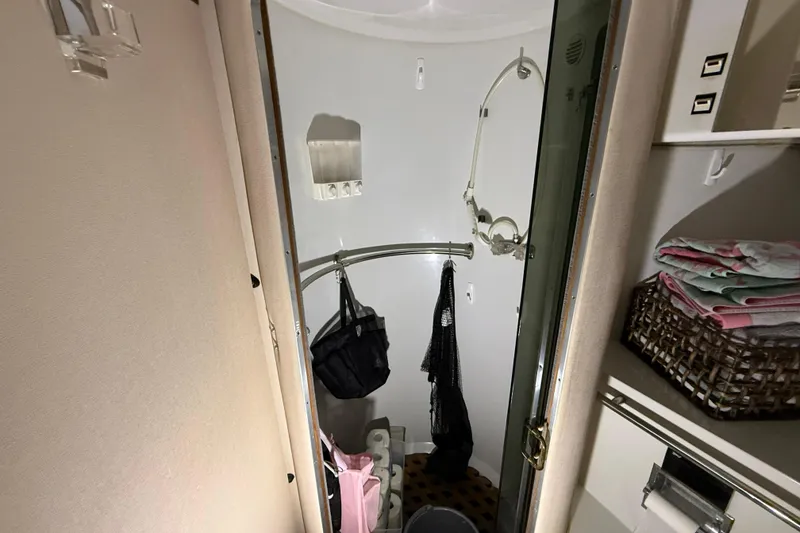 Slide: The Image of 1988 Trojan 13 Meter Express 430 yacht bathroom with shower and storage shelves. - 16