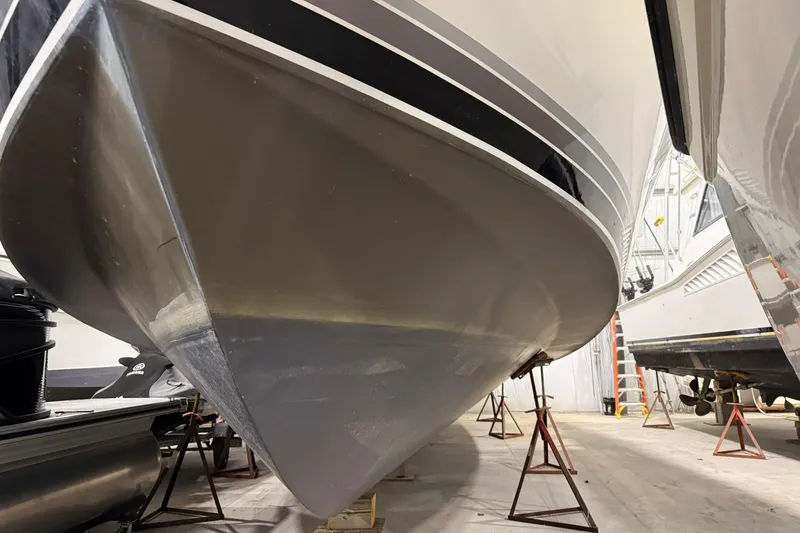 Slide: The Image of 1988 Trojan 13 Meter Express 430 yacht in storage, supported by stands. - 18