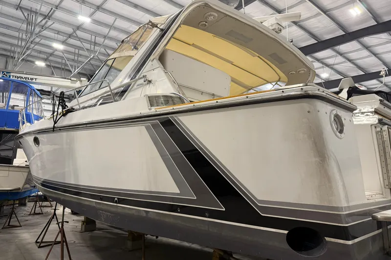 Slide: The Image of 1988 Trojan 13 Meter Express 430 yacht in a boatyard, showcasing sleek design and detailing. - 19