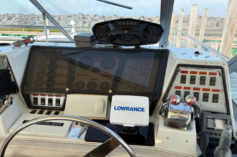 Slide: The Image of Control panel of a 1988 Trojan 13 Meter Express 430 boat with navigation equipment. - 2