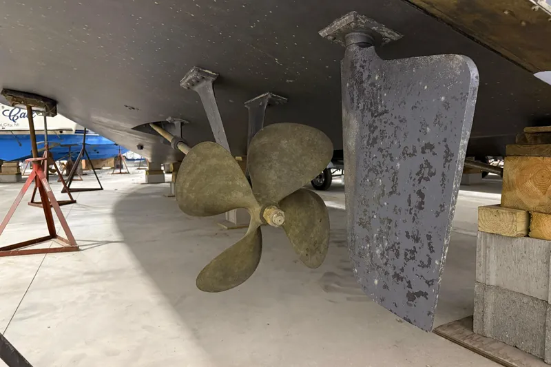 Slide: The Image of 1988 Trojan 13 Meter Express 430 boat propeller and rudder in dry dock. - 20