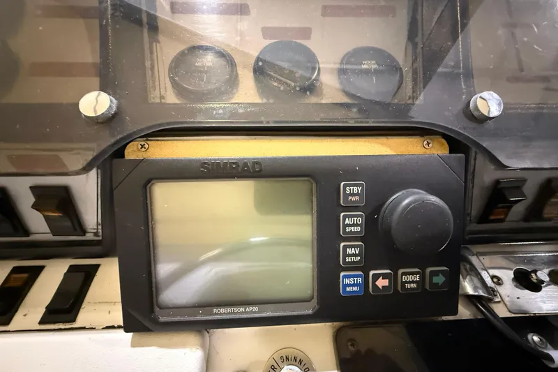 Slide: The Image of Control panel of a 1988 Trojan 13 Meter Express 430 boat with Simrad Robertson AP20. - 25