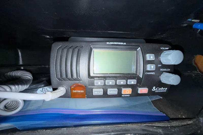 Slide: The Image of Cobra Marine radio in a 1988 Trojan 13 Meter Express 430 boat, featuring distress button. - 28