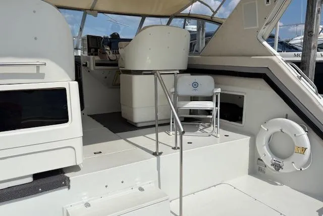 Slide: The Image of 1988 Trojan 13 Meter Express 430 yacht interior with helm, seating, and life preserver. - 3
