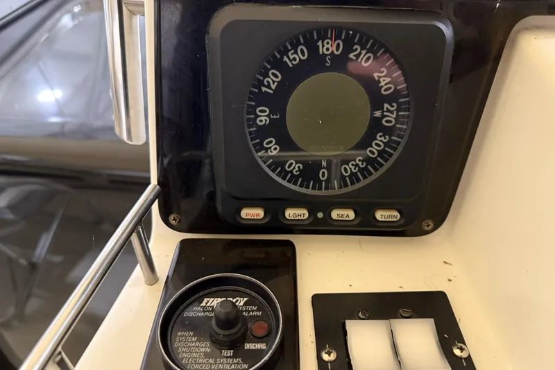 Slide: The Image of 1988 Trojan 13 Meter Express 430 boat dashboard with compass and control panel. - 35