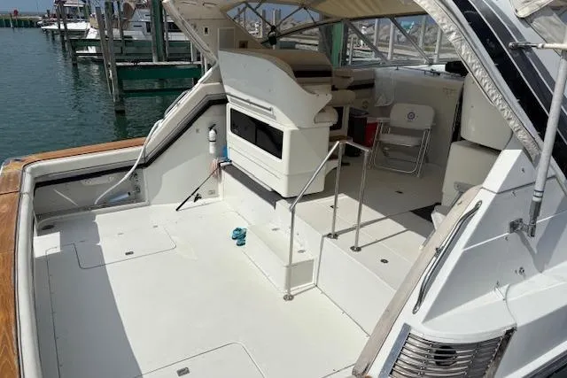 Slide: The Image of 1988 Trojan 13 Meter Express 430 yacht with spacious deck and seating area. - 4