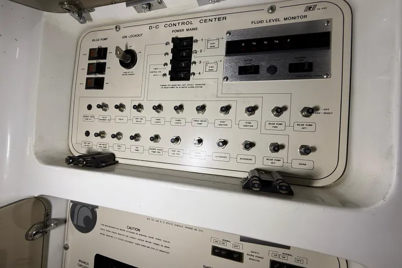 Slide: The Image of 1988 Trojan 13 Meter Express 430 control panel with switches and fluid level monitor. - 40