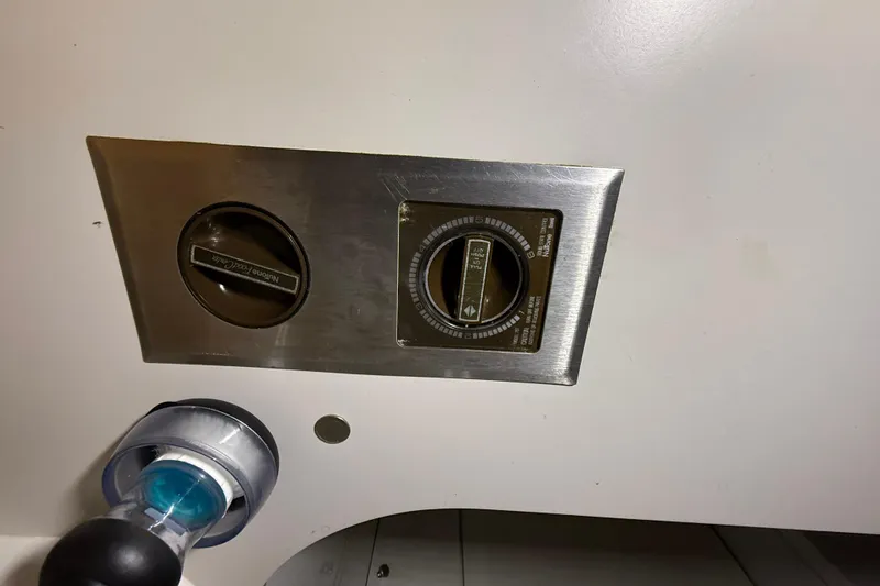 Slide: The Image of Control panel of a 1988 Trojan 13 Meter Express 430 boat, featuring dials and switches. - 41