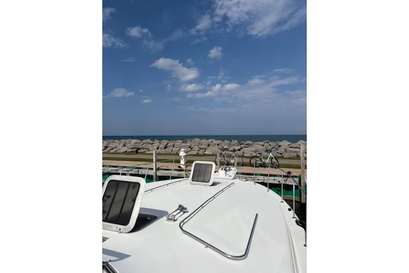 Slide: The Image of 1988 Trojan 13 Meter Express 430 yacht docked with ocean view and clear sky. - 45