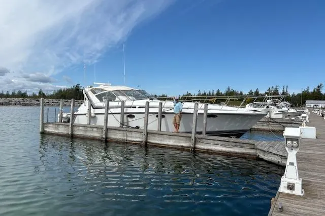 Slide: The Image of 1988 Trojan 13 Meter Express 430 docked at marina under clear blue sky. - 46