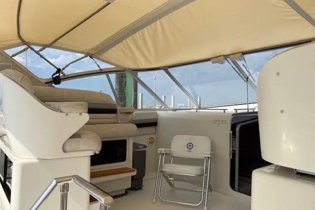 Slide: The Image of 1988 Trojan 13 Meter Express 430 yacht interior with seating and helm under canopy. - 5
