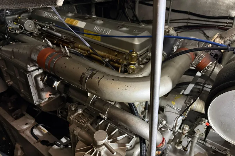 Slide: The Image of Engine of a 1988 Trojan 13 Meter Express 430 boat, showcasing intricate mechanical components. - 51