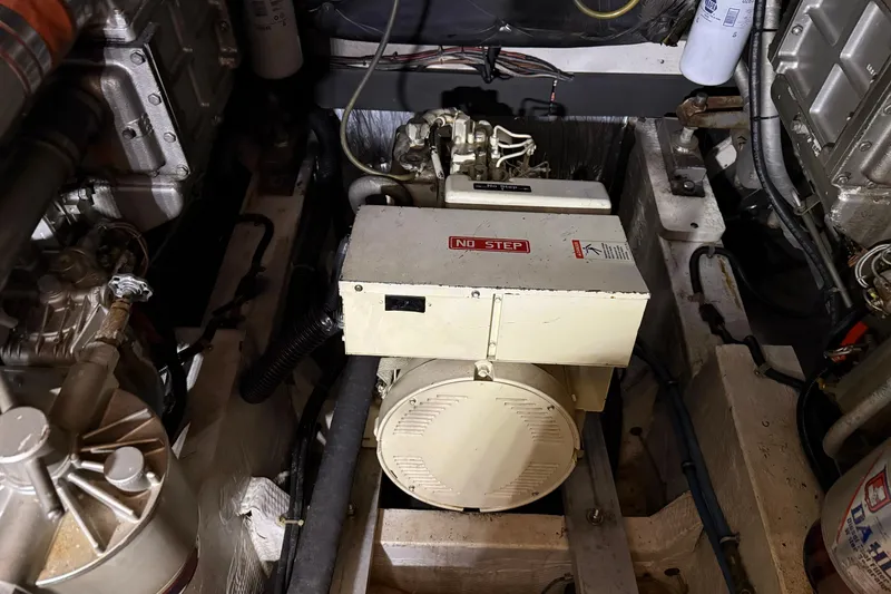 Slide: The Image of Engine room of a 1988 Trojan 13 Meter Express 430 boat, featuring machinery and components. - 54