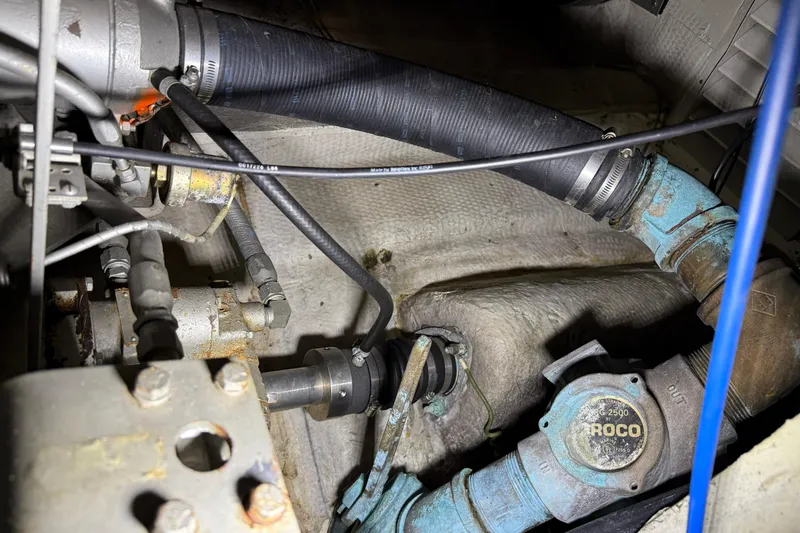 Slide: The Image of Engine compartment of 1988 Trojan 13 Meter Express 430 with hoses and mechanical components. - 55