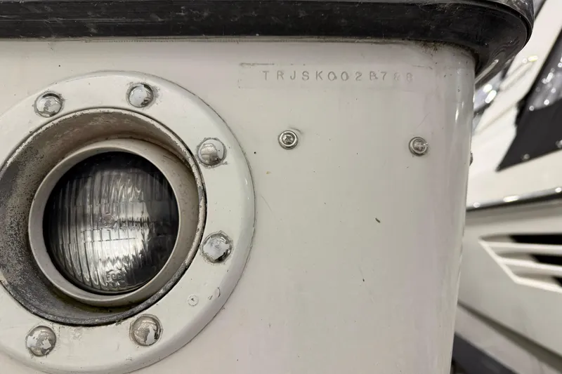 Slide: The Image of Close-up of a 1988 Trojan 13 Meter Express 430 boat light and hull details. - 57