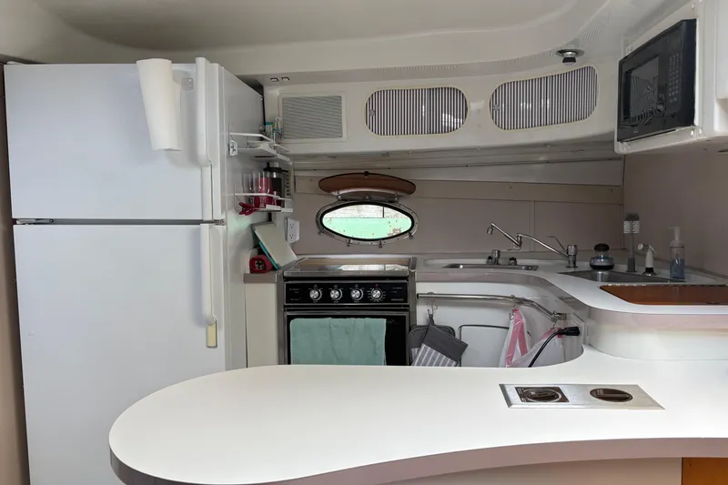 Slide: The Image of 1988 Trojan 13 Meter Express 430 yacht kitchen with modern appliances and sleek design. - 6