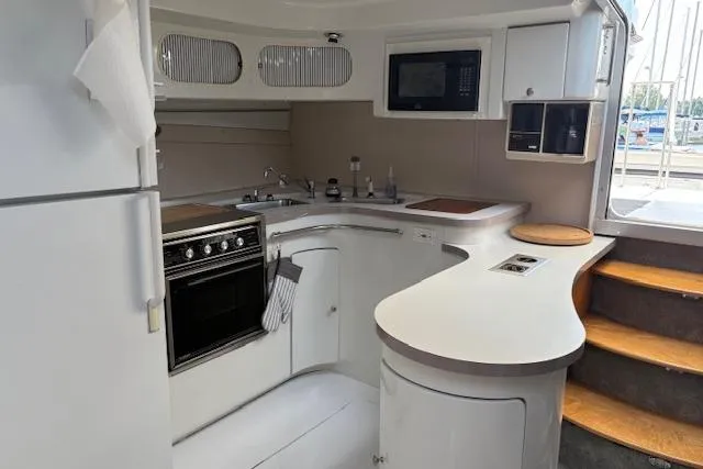 Slide: The Image of 1988 Trojan 13 Meter Express 430 yacht kitchen with modern appliances and sleek design. - 8