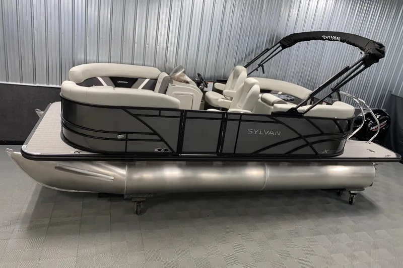 The Image of 2026 Sylvan Mirage X1 pontoon boat in showroom, featuring sleek design and comfortable seating. - 0