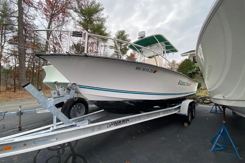 The Image of 2005 Key Largo 236 Center Console boat on trailer, parked outdoors. - 1