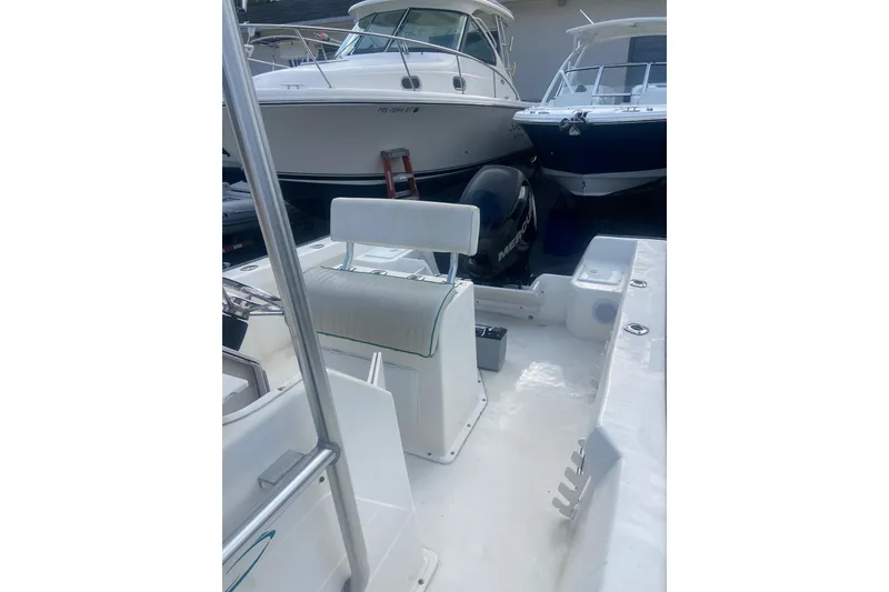 Slide: The Image of 2005 Key Largo 236 Center Console boat interior with seating and motor. - 10
