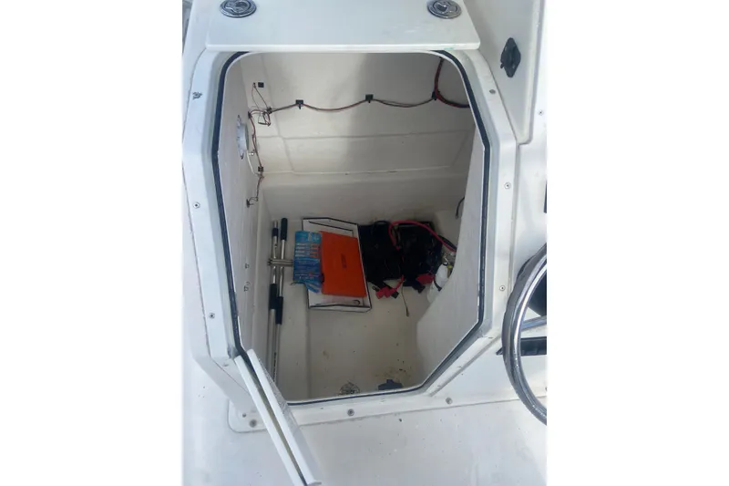 Slide: The Image of Open storage compartment in 2005 Key Largo 236 Center Console boat. - 11