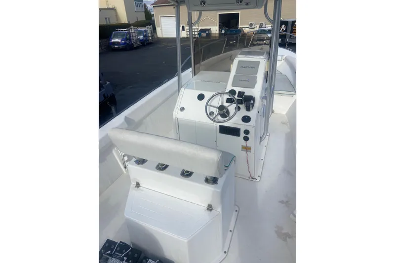 Slide: The Image of 2005 Key Largo 236 Center Console boat interior with steering wheel and Garmin navigation system. - 16