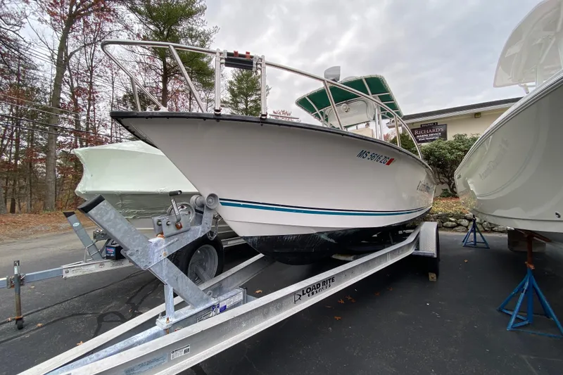 Slide: The Image of 2005 Key Largo 236 Center Console boat on trailer, parked outdoors. - 17