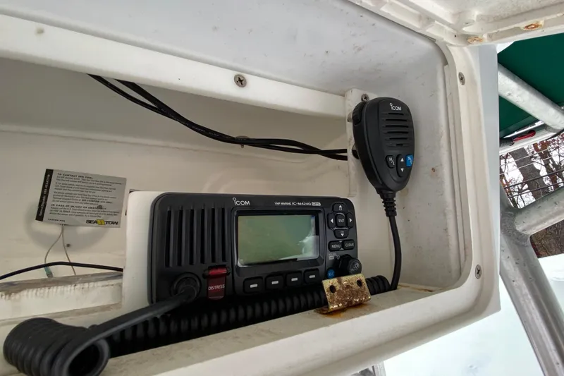 Slide: The Image of 2005 Key Largo 236 Center Console with Icom marine radio and microphone in storage compartment. - 6