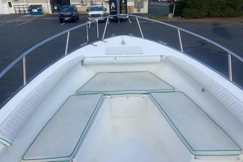 Slide: The Image of 2005 Key Largo 236 Center Console boat with cushioned seating and stainless steel railings. - 8