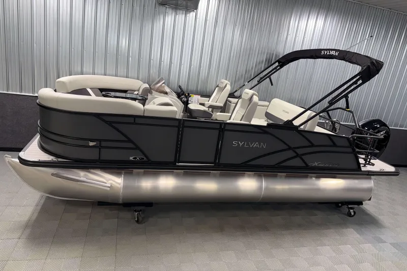 The Image of 2026 Sylvan Mirage X1 pontoon boat in showroom, featuring sleek design and modern seating. - 0