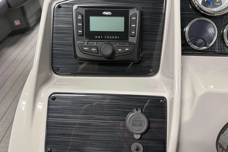 Slide: The Image of Control panel of 2026 Sylvan Mirage X1 boat with audio system and gauges. - 12